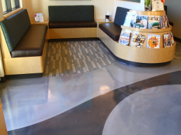 Metallic epoxy floor with accent color in a Las Vegas waiting room.