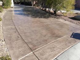 Image of a concrete driveway that's been recolored to a warm gray and resealed.