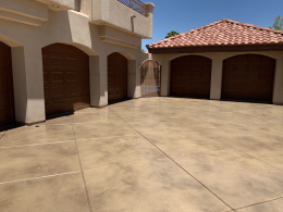 Image of a sand-colored stained concrete driveway.