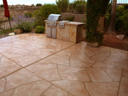 Image of a wide-cut flagstone overlay on a concrete patio and outdoor kitchen.