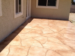 Image of a sand and terracotta-stained flagstone overlay on a concrete patio.