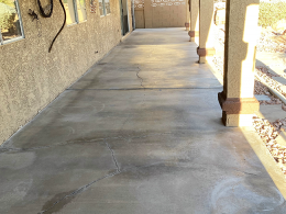 Image of a cracked concrete patio before it has a flagstone overlay installed.