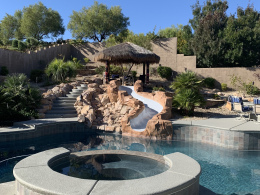 Concrete texturing, tilework, and faux rock water slide on a Las Vegas pool deck.