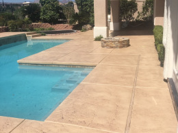 Closeup of stamped and stained concrete pool deck in Las Vegas.